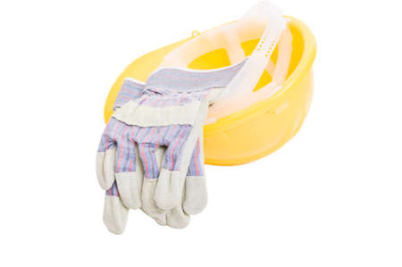 Builder yellow hat and leather gloves isolated on white studio backgroundの写真素材