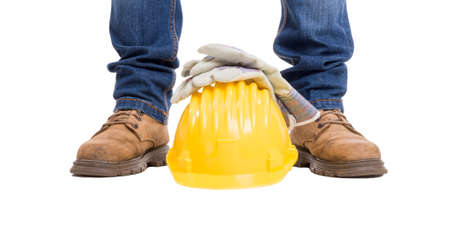 Construction builder feet, helmet and gloves. Wide picture isolated on white backgroundの写真素材