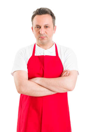 Confident butcher or supermarket employee wearing red apronの写真素材