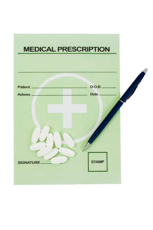 Medical prescription with pills and a pen on it. Pharmacy concept isolated on white tableの写真素材