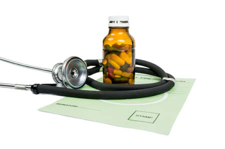 Pill prescription concept with bottle of capsules, rx and stethoscopeの写真素材