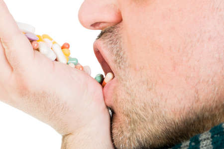 Man taking pills as a medicine abuse or addiction conceptの写真素材
