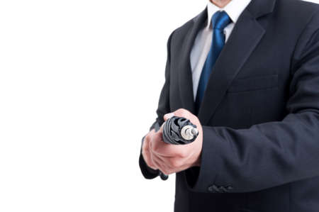Business man, hitman or special secret agent holding umbrella like a riffleの写真素材