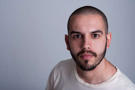 Portrait of a handsome young man with short hair and beard