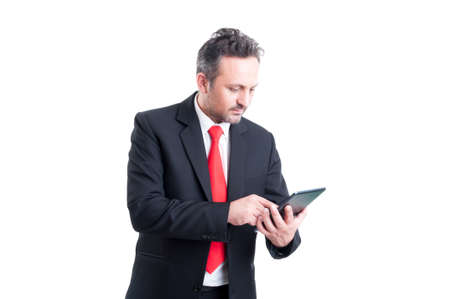Busy business man holding and using wireless tabletの写真素材