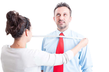 Professional tailor woman taking measures for business clothes