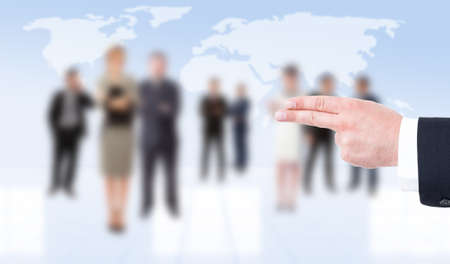 Business man hand showing pistol gesture on business people backgroundの写真素材