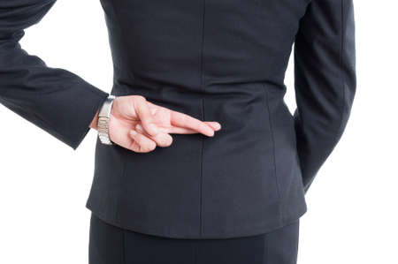 Business woman making good luck gesture with fingers crossed behindの写真素材
