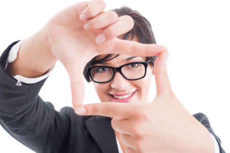 Female business manager framing the face with fingers on white backgroundの写真素材