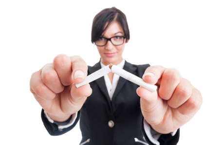 Business woman breaking a cigarette in half. Stop or quit smoking concept.の写真素材