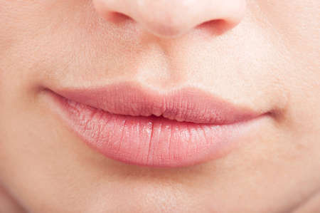 Closeup of perfect natural color female lips. Botox or hylauronic acid conceptの写真素材