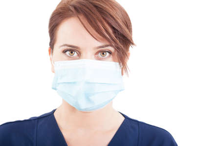 Confident woman doctor face wearing surgical mask on white backgroundの写真素材