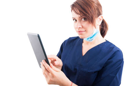 Beautiful woman doctor holding a wireless tablet isolated on white background