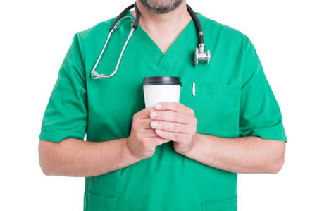 Doctor in coffee break concept with male medic holding a coffee to-go cup