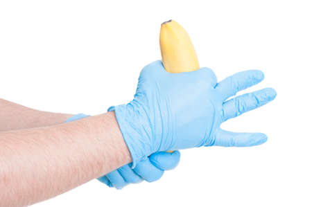 Doctor hands making obscene gesture with a banana for Condom apply