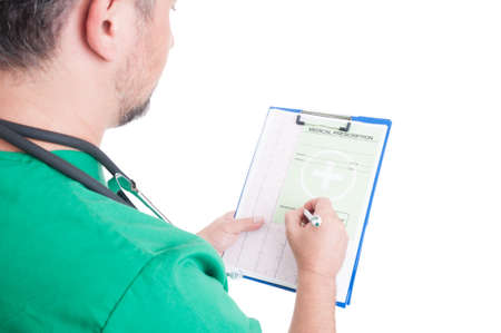 Doctor or medic writing a medical prescription on a clipboardの写真素材