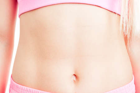 Closeup of fit and sexy female or woman abdomen with slim waistlineの写真素材