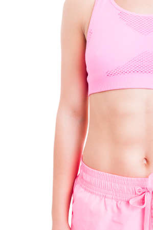 Half image of fitness instructor female body on white background with copy space and vertical text areaの写真素材