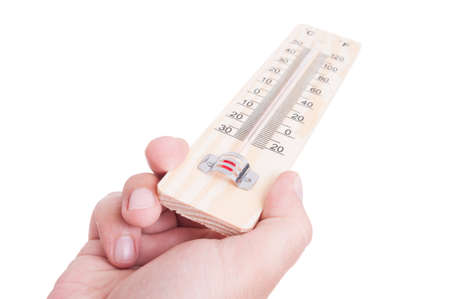 Hand holding wooden classic thermometer isolated on whiteの写真素材