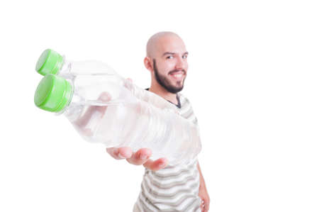 Smiling man holding two bottles of cold water isolated on white