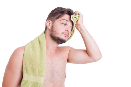 Naked man wiping forehead after refreshing shower in sumer heat seasonの写真素材