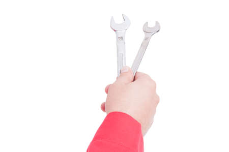 Mechanic or plumber hand offering wrenches isolated on whiteの写真素材