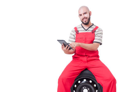 Modern mechanic using wireless tablet or pad. Friendly car assistance conceptの写真素材