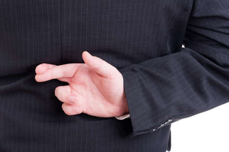 Accountant or financial manager making fingers crossed behind back as wishing metaphore gestureの写真素材