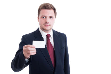 Businessman wearing suit and showing blank empty business card with copy spaceの写真素材