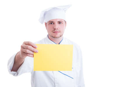 Chef or cook holding yellow paper card with blank advertising copy spaceの写真素材