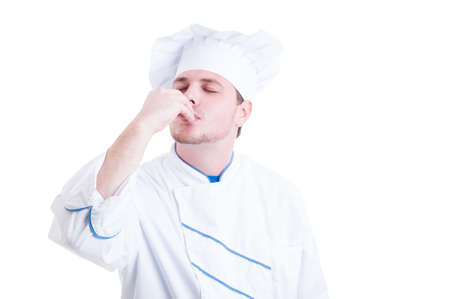 Chef or cook making delicious gesture by kissing fingers isolated on whiteの写真素材