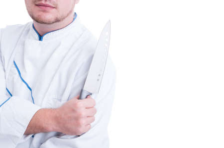 Shoulder view of a cook or chef holding big knife isolated on whiteの写真素材