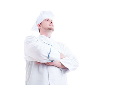 Hero shot of a proud and confident chef or cook looking up with arms crossed isolated on whiteの写真素材