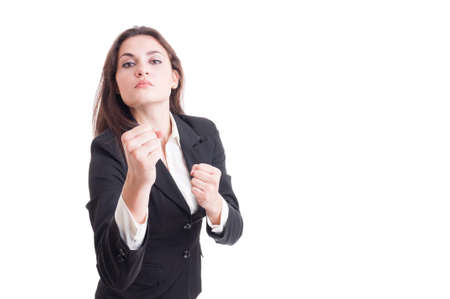 Young business woman acting aggressive showing fists isolated on white backgroundの写真素材