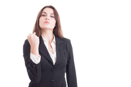 Bossy business woman showing fist as powerful leader of the company isolated on white backgroundの写真素材