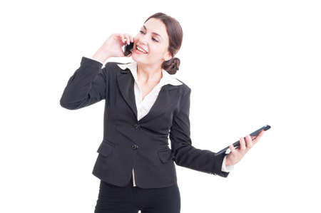Happy smiling young business woman using tablet and phone.  Multitasking employee concept isolated on white backgroundの写真素材