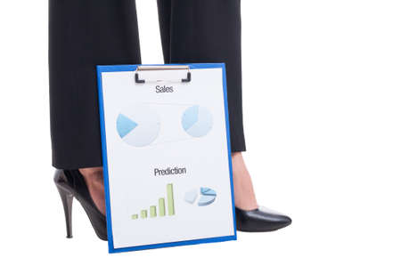 Sexy business woman feet with high heels and financial reports with charts, graphs and piechartsの写真素材