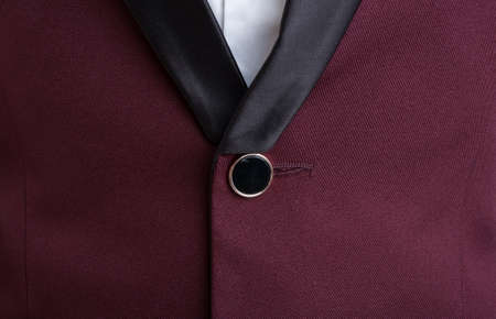 Closeup of male suit jacket closed button. Modern and fashionable business concept.