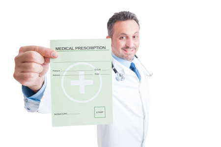 Smiling friendly doctor or medic showing medical prescription isolated on white backgroundの写真素材