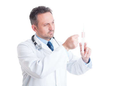 Doctor or medic preparing and tapping syringe for injection isolated on white backgroundの写真素材