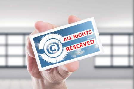 Hand holding copyright all rights reserved concept cardの写真素材