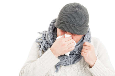 Sick man blowing his nose because of flu isolated on white background
