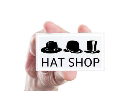 Hat shop concept with cap shape or silhouette on a cardの写真素材
