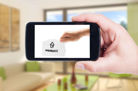 House insurance concept on smartphone display or cellphone screenの写真素材