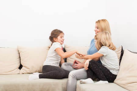 Happy lifestyle concept with mother and young daughters spending time together