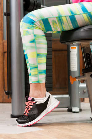 Closeup with woman feet wearing sport shoes in the gym