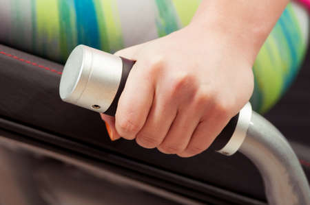 Closeup of female hand holding a handle machine in the gym