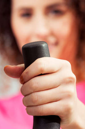 Close-up of cute woman hand holding a bike handle during the gym workout