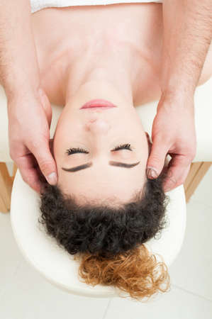 Portrait of beautiful woman with fresh skin taking a massage in spa and beauty salonの写真素材