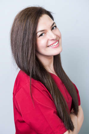 Beautiful female doctor posing single on gray backgroundの写真素材